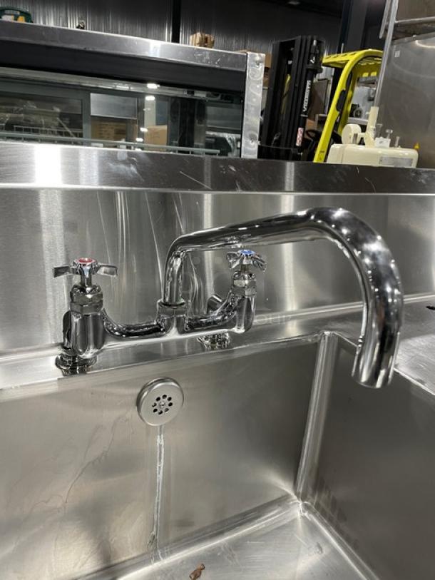 Custom stainless steel sink with single compartment, backsplash, swivel spout faucet, dual-sided undershelf on legs, excellent condition.