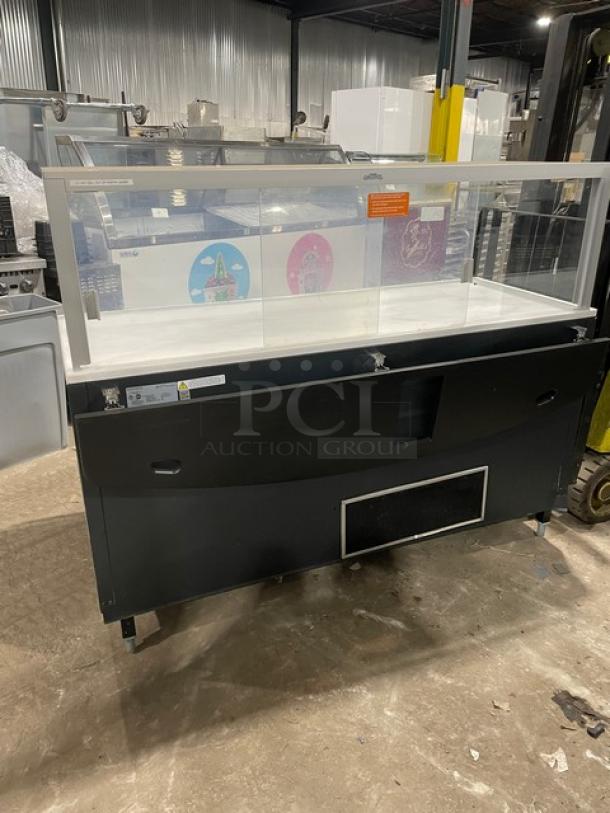 Structural Concepts Model SBZ6652DR black refrigerated open merchandiser with glass showcase, rear sliding doors, on legs.