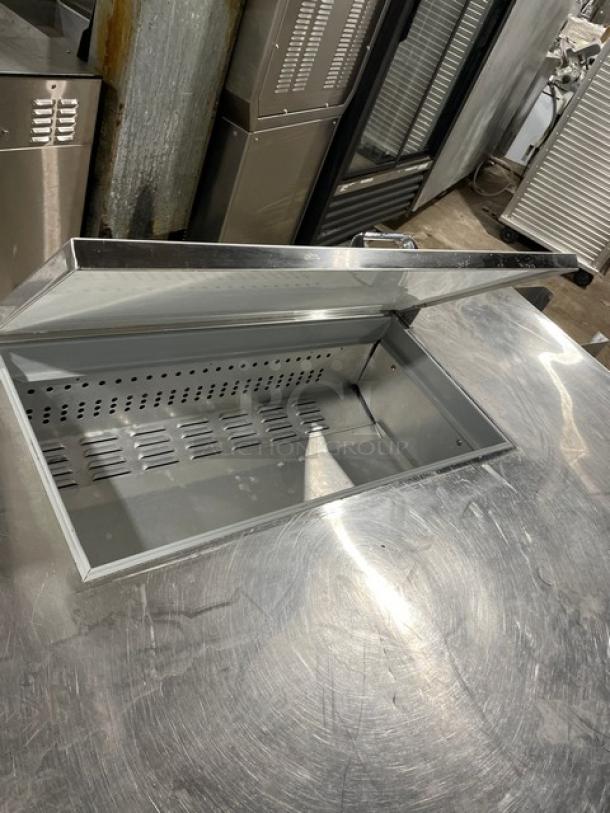 Continental Commercial Stainless Steel Refrigerated Prep Table, Model RA68NB, with poly coated wired rack, open top view.