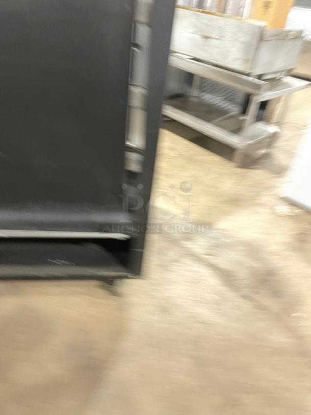 Vulcan Model 1013776 black 5-tier bakery merchandiser with stainless steel interior, enclosed storage, and casters.