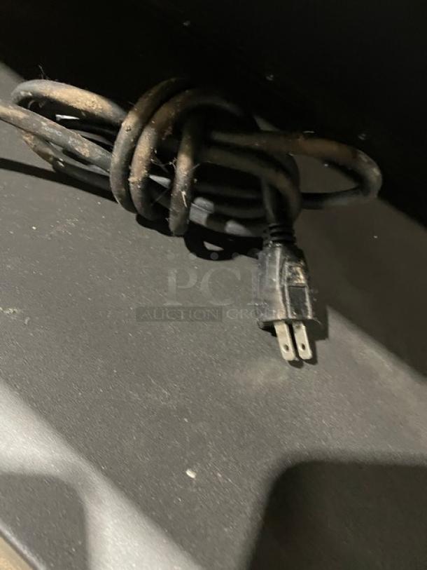 Black electrical cord for Vulcan Model 1013776 bakery display, shown coiled; features standard 120V plug. Dust visible.
