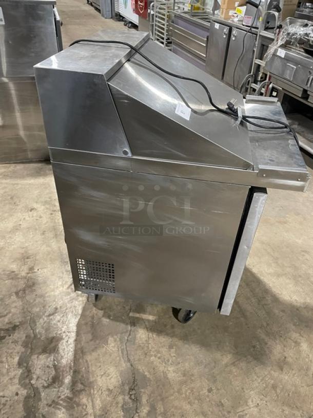 Atosa 2021 stainless steel single door refrigerated prep table, model MSF8305GR, on casters with poly-coated rack.