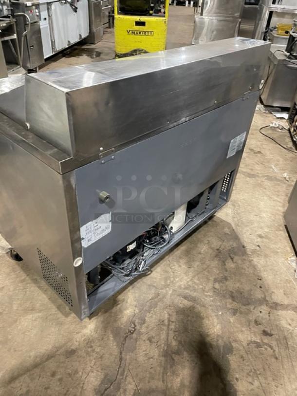 Turbo Air MST-48-N stainless steel 2-door refrigerated prep table with poly coated rack, 115V, on casters.