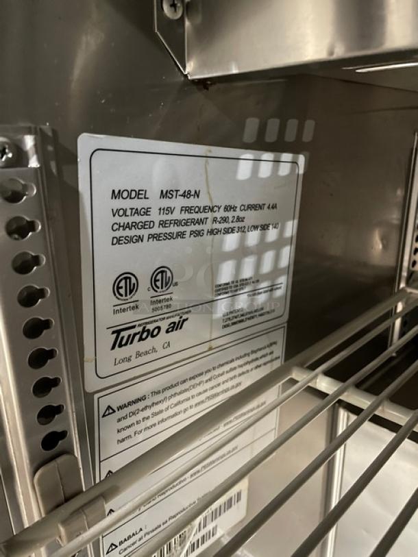 Turbo Air MST-48-N label showing 115V details, design pressure, and certifications. Includes poly coated wire rack.