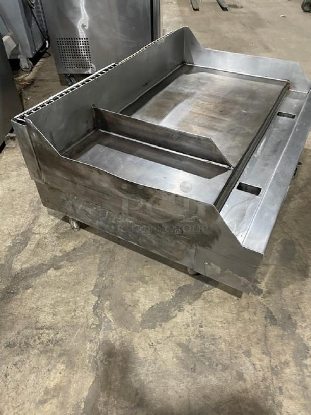 Woodstone commercial stainless steel natural gas griddle with split-top, back, and side splash. Excellent condition.