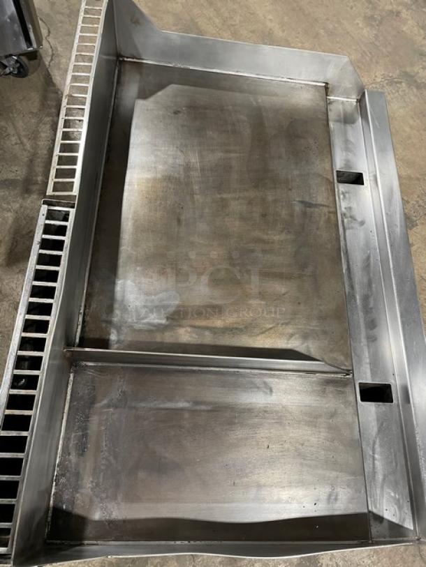 Woodstone commercial stainless steel split-top plancha griddle with back and side splash, natural gas powered, used condition.