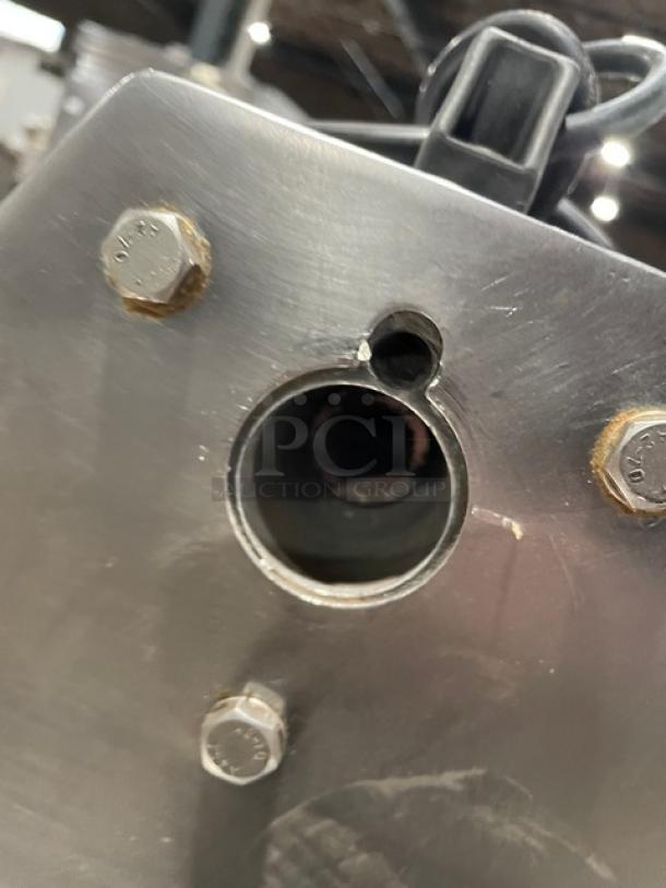 American Eagle AE-G22N stainless steel meat grinder, 115V, electric bench model, showing mount and leg area, used condition.