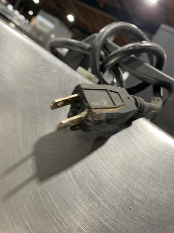 American Eagle AE-G22N meat grinder plug and power cord on stainless steel surface; commercial-grade, 115V, single phase.