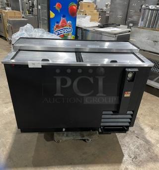 True TD-50-18 commercial black 50" bottle cooler with stainless steel worktop, dual sliding lids, 115V, SN: 6945613.