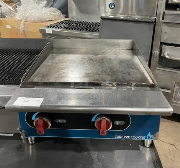 Core Pro Cooking 24" stainless steel flat griddle, model CPG24M. Features back and side splashes, natural gas powered, on legs.