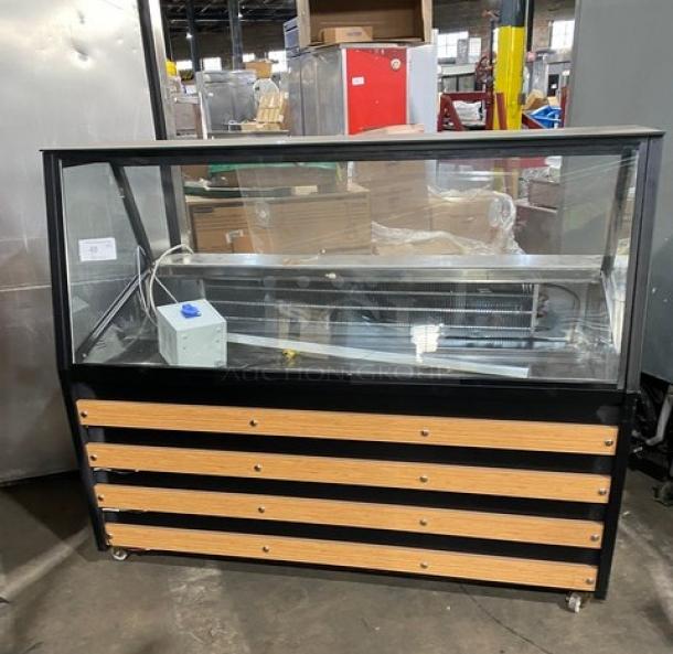 Commercial 60" refrigerated display case with slanted glass, wood-slatted base, prep area, storage, and sliding doors on casters.