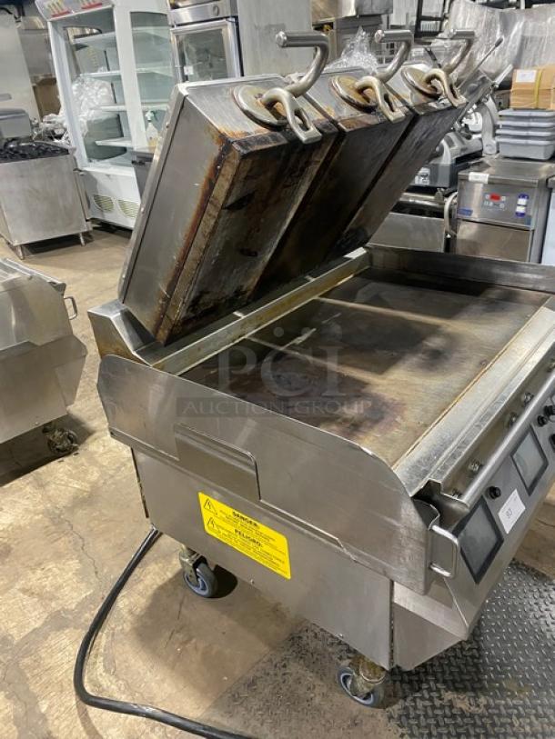 Taylor stainless steel 36" griddle, model L81123, with triple platens, programmable controls, on casters, good condition.