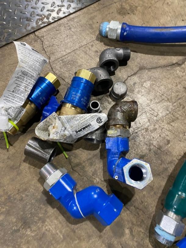 Dormont commercial gas connectors, assorted types in mixed condition, with visible tags and fittings.