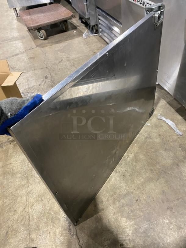 Commercial stainless steel solid single door with bracket and screws, in good condition, suitable for industrial use.