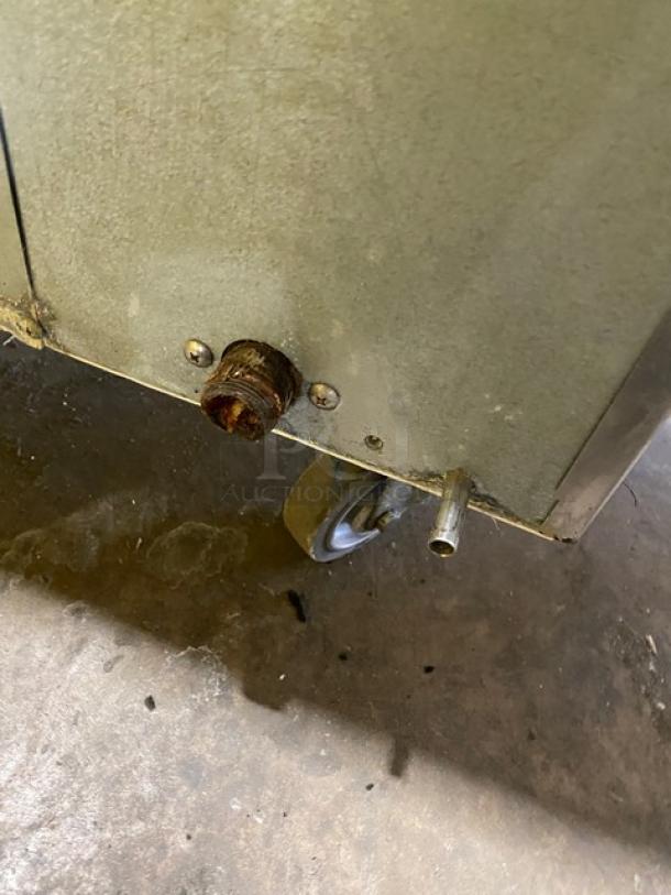 Hoshizaki KM-515MAH ice machine underside with visible casters and drainage pipes. Stainless steel, used condition.