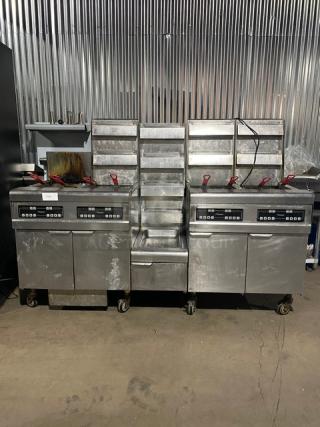 Frymaster FMPH455SC 4-bay stainless steel fryer system with center dump, backsplash, basket hangers, digital controls, on casters.