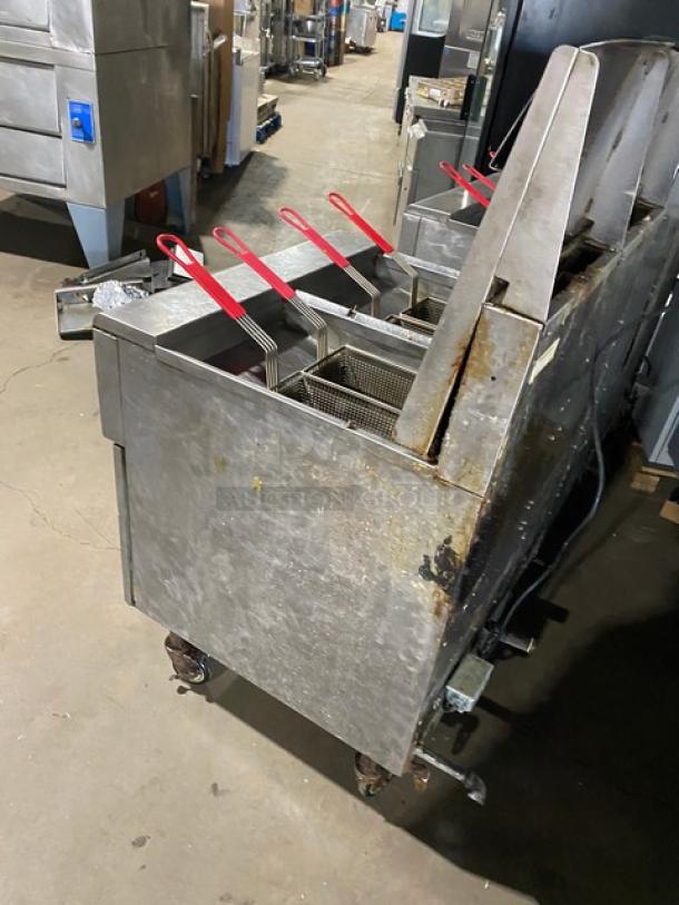 Frymaster FMPH455SC 4-bay stainless steel fryer, natural gas, digital control, oil filter, center dump, casters, used condition.