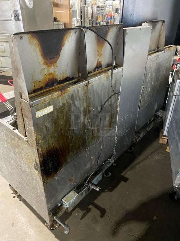 Frymaster 4-bay stainless steel deep fat fryer, model FMPH455SC, with digital control, oil filter, and basket hangers on casters.