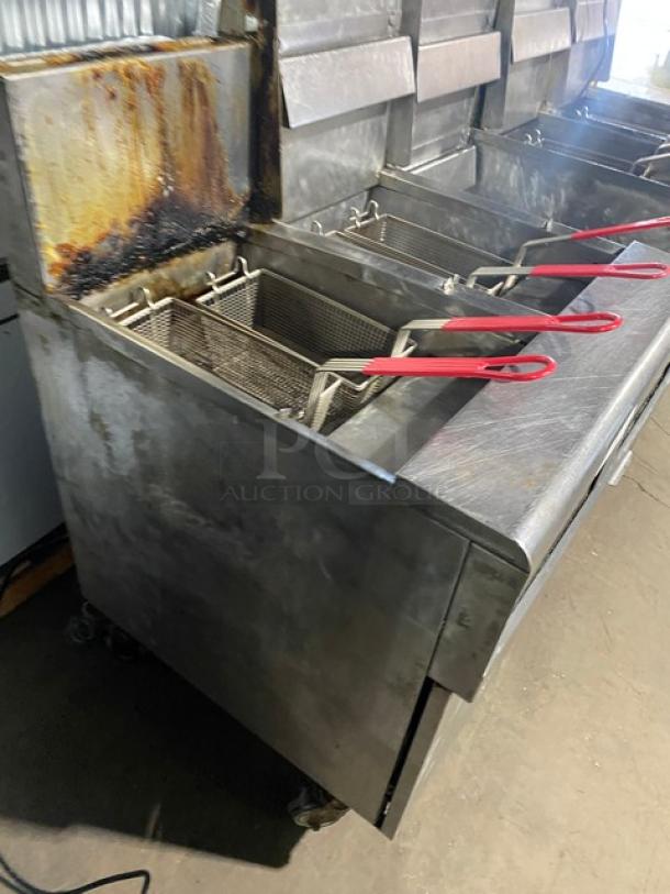 Frymaster FMPH455SC 4-bay stainless steel deep fat fryer system, natural gas, 50 lb capacity, center dump station, oil filter, digital control, on casters.