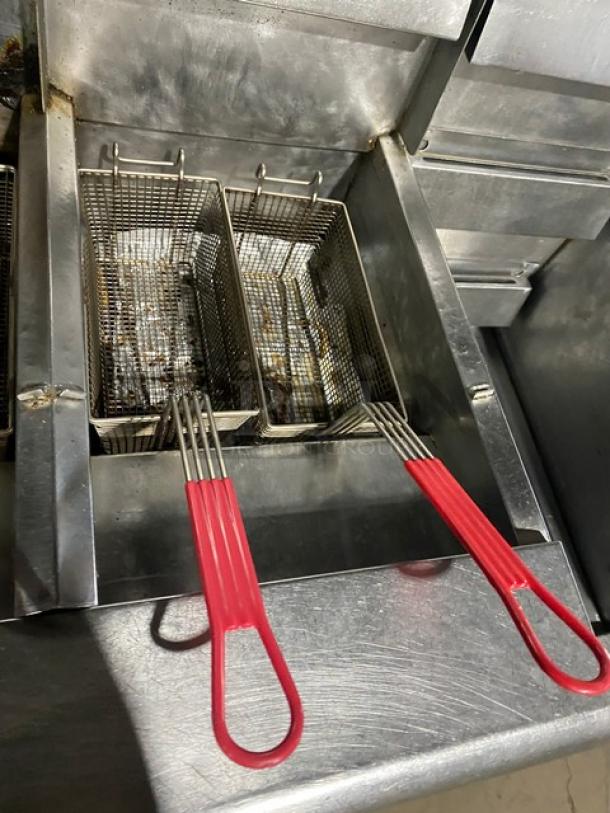 Frymaster FMPH455SC 4-bay deep fryer, stainless steel, with red-handled baskets, center dump station, and digital controls.