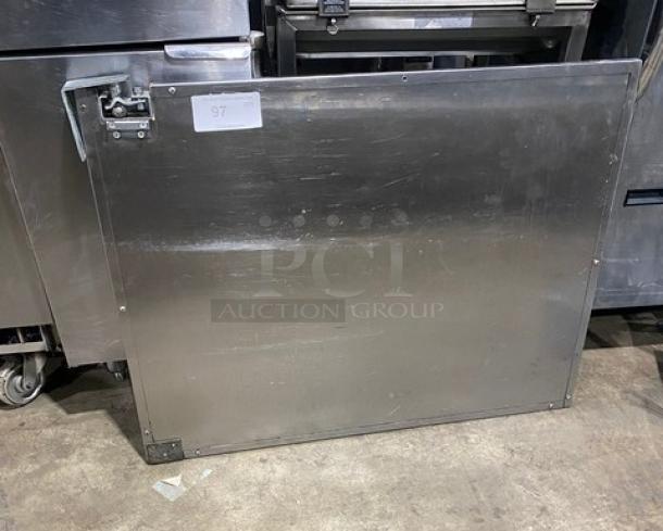 Commercial stainless steel single door with bracket and screws; robust, slightly used condition, ideal for kitchen equipment.