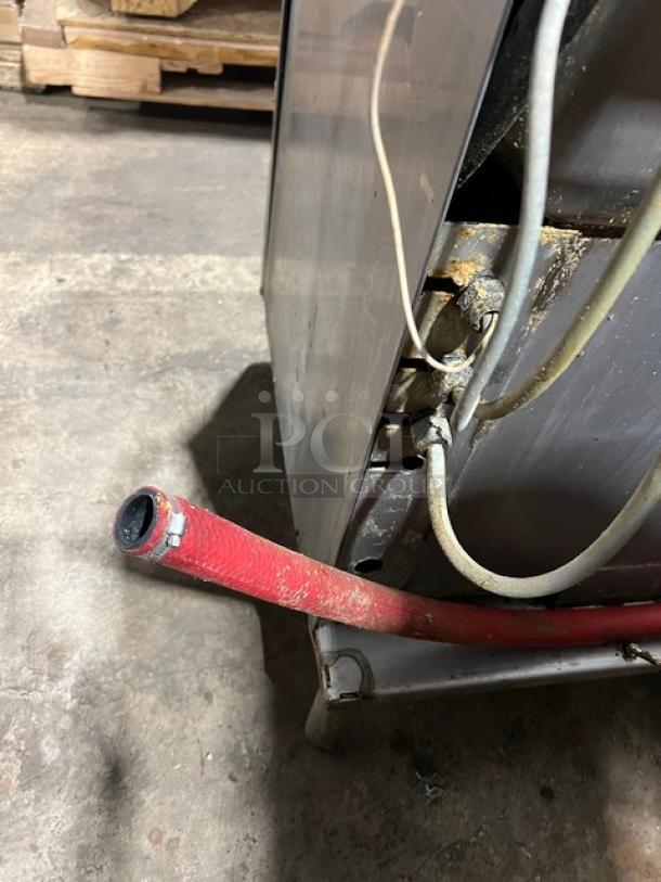 Hobart Advansys stainless steel door-type ware washing machine, electric powered, on legs, visible wear.