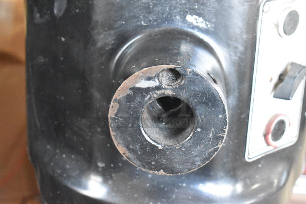 Close-up of Hobart L-800 mixer body, showing worn, scratched surface. Visible control panel with switches. 80-quart capacity.