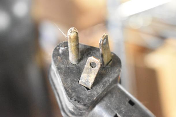 Close-up of a three-prong plug from a Hobart L-800 mixer, showing wear and usability of the electrical connection.