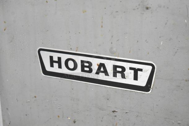 Hobart H-600T commercial mixer label on a gray surface, indicating brand and model.