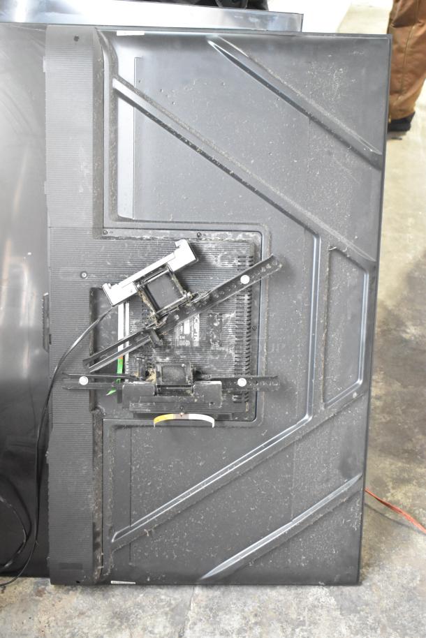 Three televisions, including a Sceptre model, shown in used condition. Mounting brackets and cables visible on the back.