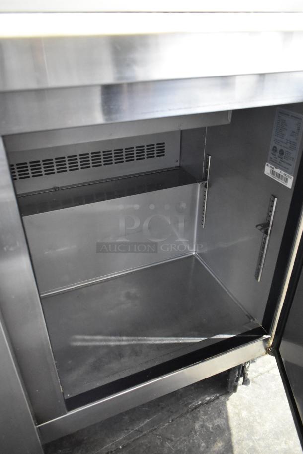Dukers DSP48 sandwich prep table, stainless steel interior, commercial casters, visible vent, label lists specs, excellent condition.
