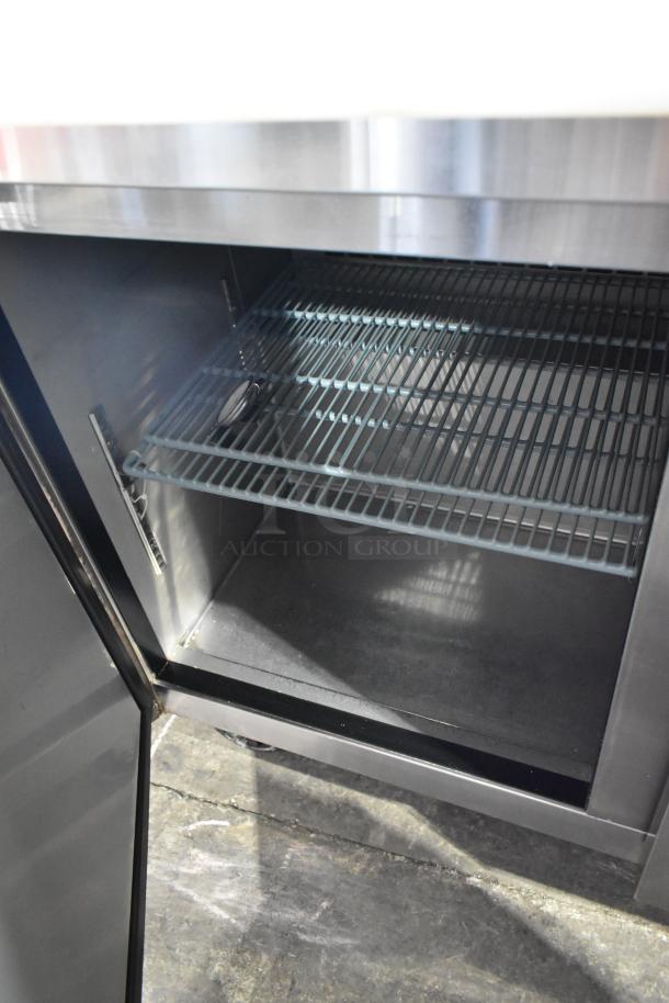 Dukers DSP48 commercial prep table interior, featuring wire shelving. Stainless steel, on casters. 115V, 1 phase.