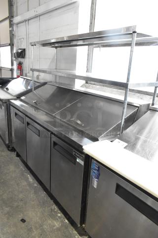 Dukers commercial sandwich prep table with Bain Marie, two-tier overshelf, and casters. 115 volts, 1 phase.