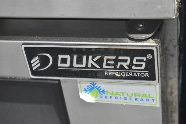 Dukers Commercial Sandwich Salad Prep Table with 2-tier overshelf, on casters. Features natural refrigerant label.