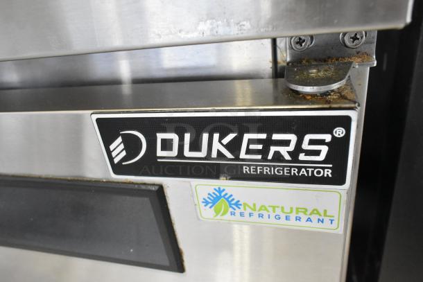 Dukers commercial sandwich salad prep table label, highlighting brand and natural refrigerant feature.