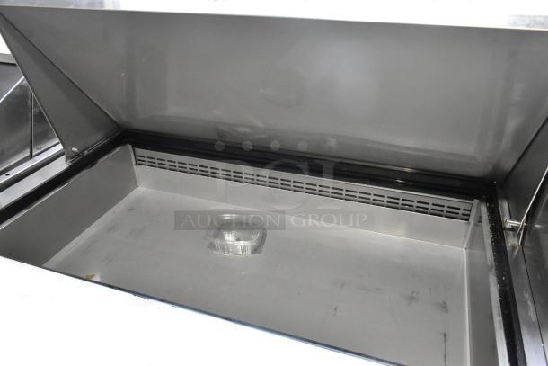 Dukers Commercial Sandwich Prep Table, stainless steel, mega top, on commercial casters. 115 Volts, 1 Phase. Clean interior.