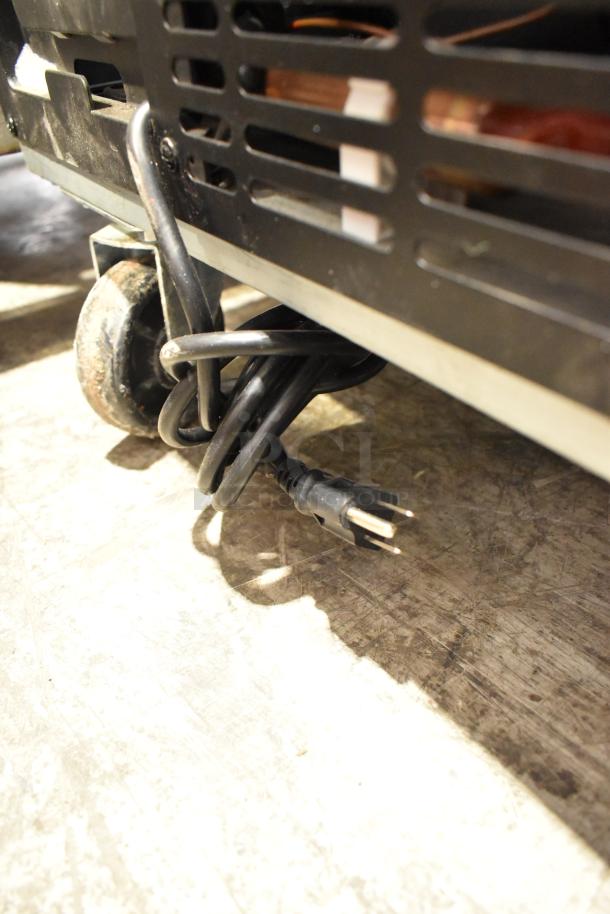 2024 Coldline UC-27R undercounter cooler detail, showing commercial caster and power cord. 115V, 1 phase. Clean condition.