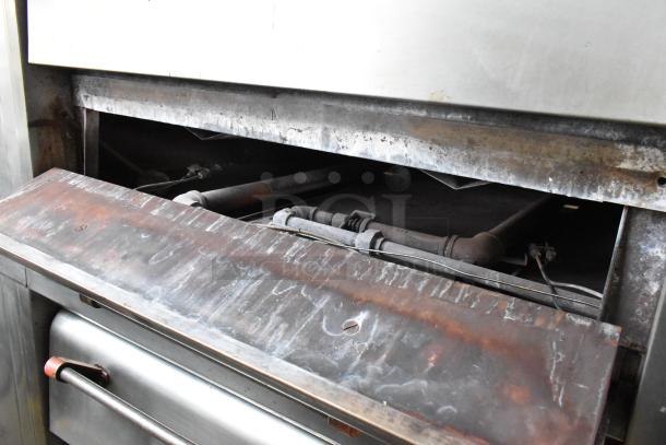 Bari M54S commercial natural gas pizza oven, single deck with cooking stones, metal legs, 80,000 BTU, visible aged surface.