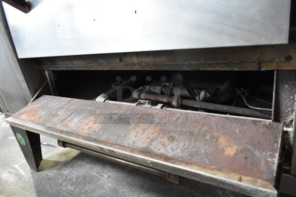 Bari M54S commercial pizza oven, natural gas, single deck, with cooking stones, metal legs, and 80,000 BTU output. Some rust visible.