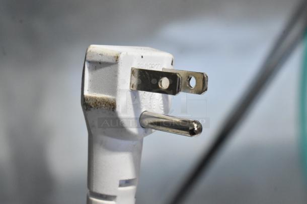 Close-up of a power plug for Vissani HMCF5W5 chest freezer, 115 volts, showing wear around prongs.