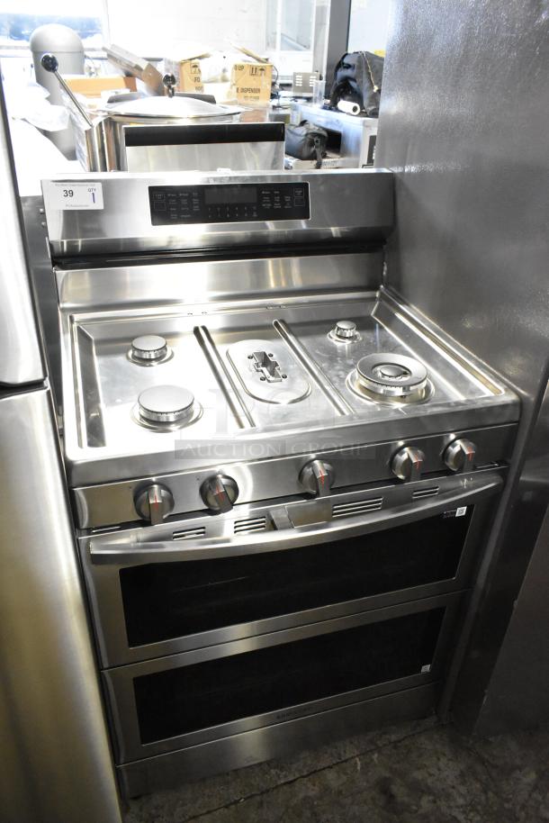 Gas-powered 4 burner range with 2 ovens, stainless steel, missing grates, panel controls visible, model label included.