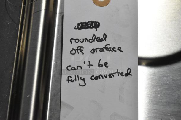 Gas powered 4 burner range with 2 ovens, missing grates. Tag note: "rounded off orifice, can't be fully converted."