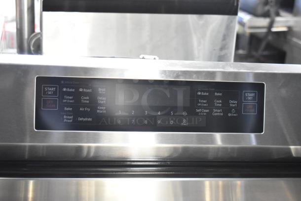 Gas powered 4 burner range with digital control panel, includes 2 ovens. Missing grates. Stainless steel finish.