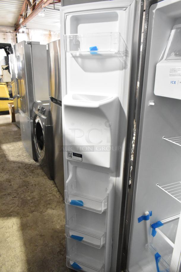 Brand new Frigidaire FRSS2623ASM cooler with freezer. Scratch and dent condition. 115V, 1 phase. Interior shelves are visible.