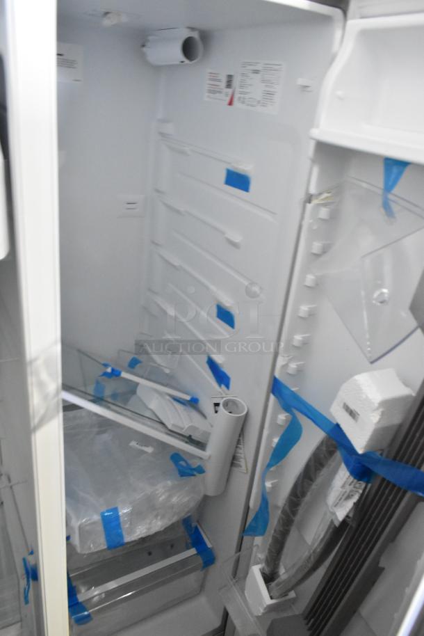 Brand new Frigidaire FRSS2623ASN cooler with freezer, scratch and dent, 115 volts, 1 phase, interior view with packing materials.