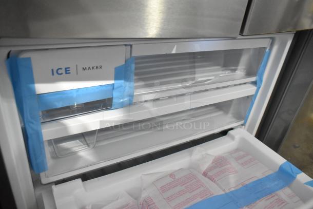 Brand new Frigidaire FRFG1723AV04 cooler with freezer, minor scratches. Features ice maker, visible protective tape.