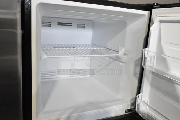 Brand new Vissani MDTF10BKES4 cooler with freezer, 115 volts, 1 phase. Interior view, white with shelf. Scratch and dent condition.
