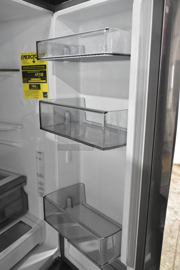 Brand new 2023 Samsung RF32CG5400SR fridge showing interior with shelves, energy label indicating $110 annual cost.