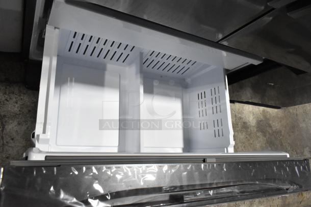 Brand new Samsung RF32CG5400SR French door refrigerator with opened freezer drawer, stainless steel finish, minor scratches.