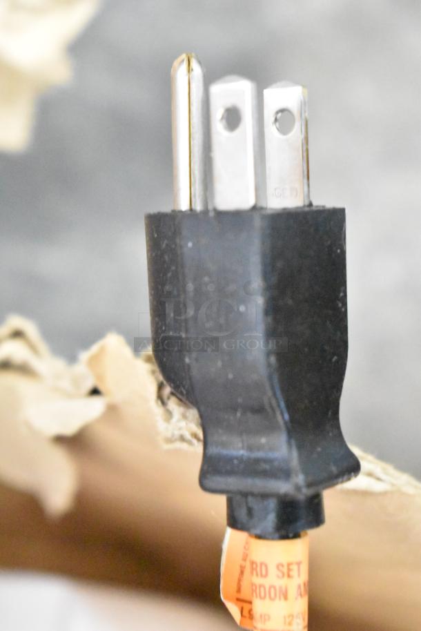 Lot of Documentor screen and tripod TPOS1225. Close-up of power plug, showing standard three-prong connection.